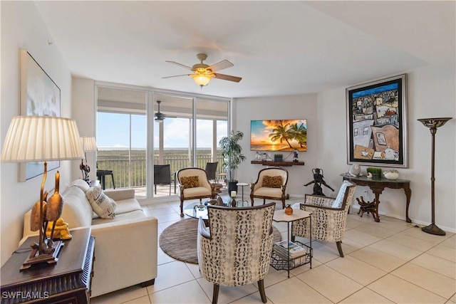 tiled living room with a wall of windows and ceiling fan