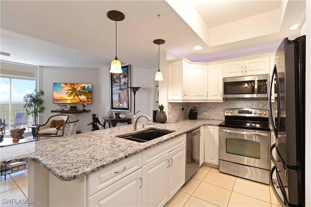 kitchen with kitchen peninsula, sink, light tile patterned flooring, and stainless steel appliances