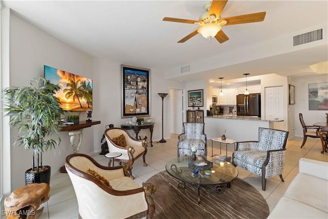 tiled living room featuring ceiling fan