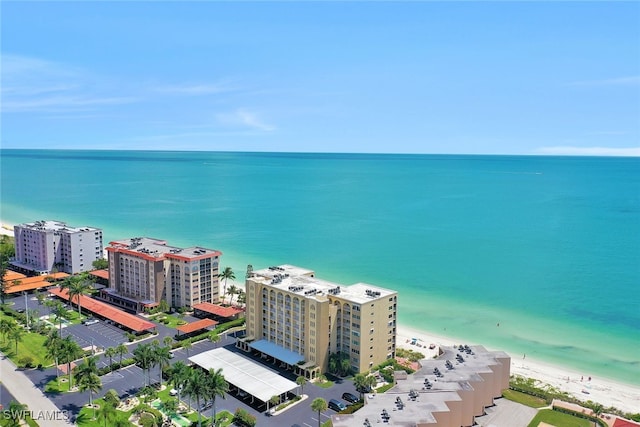 drone / aerial view featuring a water view and a beach view