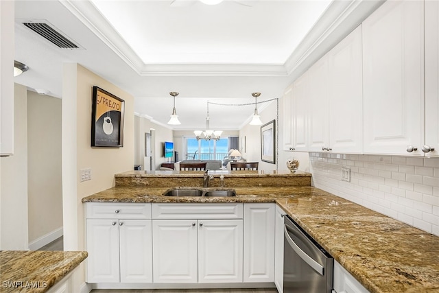 kitchen featuring stainless steel dishwasher, hanging light fixtures, sink, white cabinets, and dark stone countertops