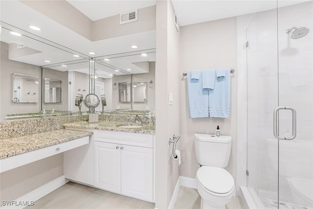 bathroom featuring a shower with door, toilet, and vanity