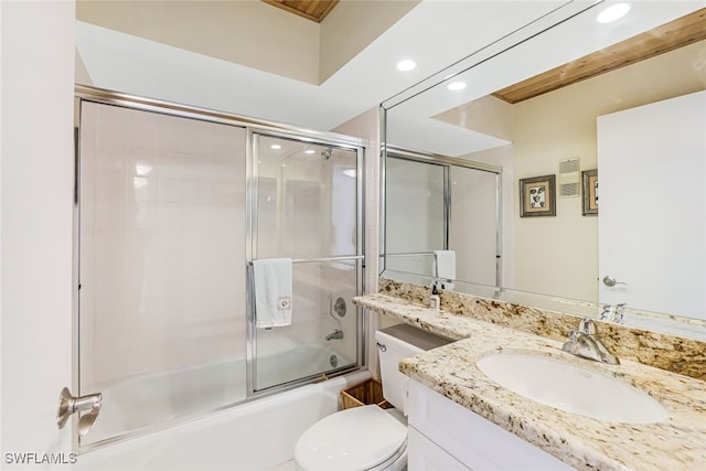 full bathroom featuring shower / bath combination with glass door, vanity, and toilet