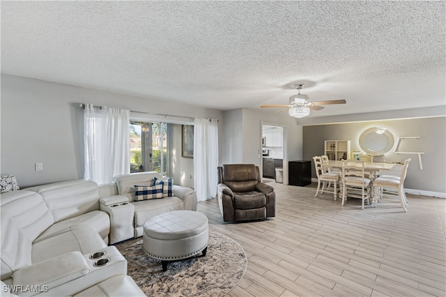 living room with french doors, a textured ceiling, light wood-type flooring, and ceiling fan