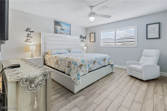 bedroom with a textured ceiling, light wood-type flooring, and ceiling fan