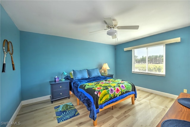 bedroom with ceiling fan and light hardwood / wood-style flooring