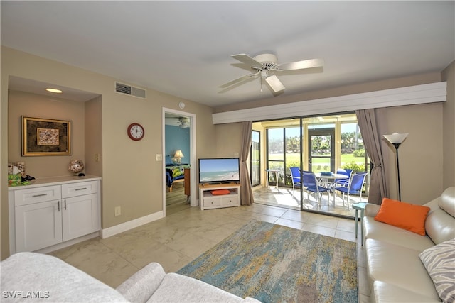 living room featuring light tile patterned flooring and ceiling fan