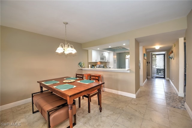 dining space featuring an inviting chandelier and light tile patterned floors