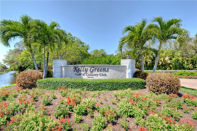 community / neighborhood sign with a water view