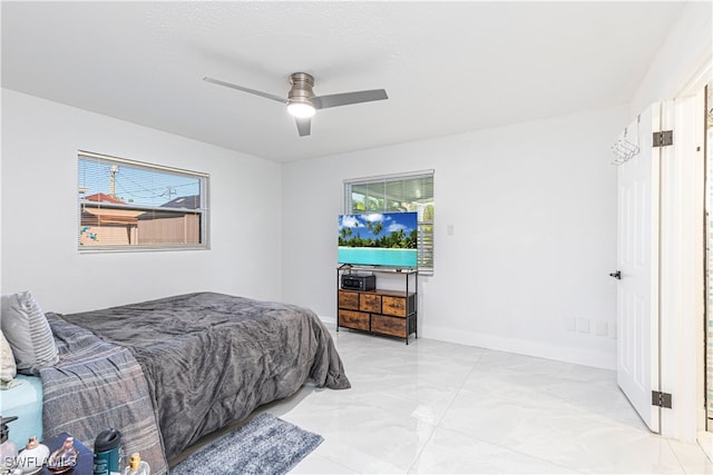 bedroom featuring multiple windows and ceiling fan