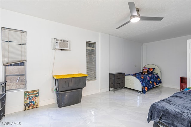 bedroom with a wall mounted AC, a textured ceiling, and ceiling fan