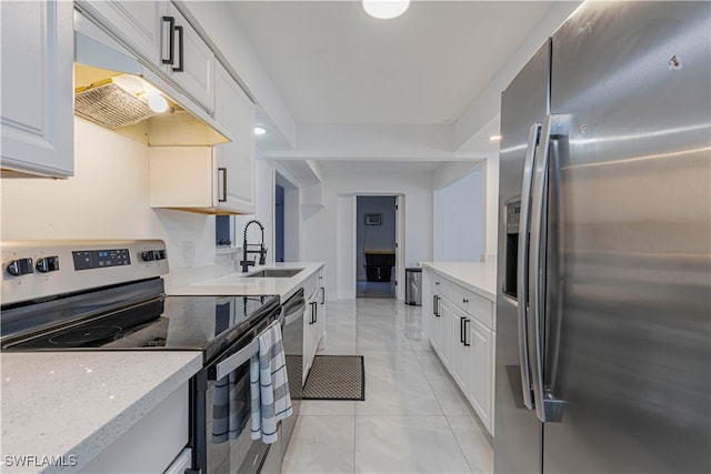 kitchen featuring sink, white cabinetry, light stone counters, and stainless steel appliances