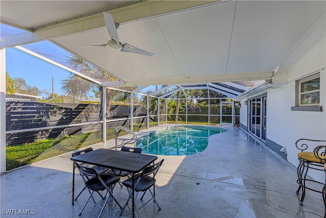 view of swimming pool with a patio, ceiling fan, and glass enclosure