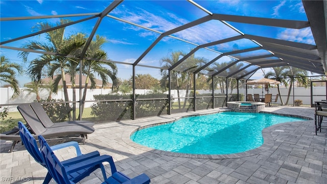 view of swimming pool featuring glass enclosure, an in ground hot tub, and a patio area