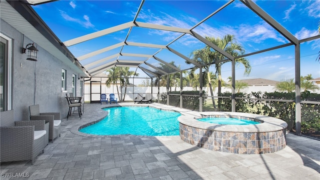 view of swimming pool featuring glass enclosure, an in ground hot tub, and a patio area