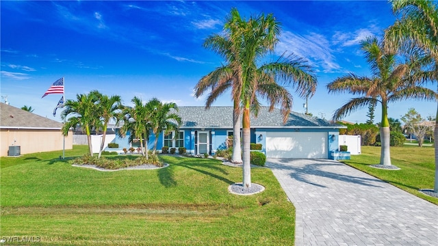 ranch-style house featuring a garage and a front yard