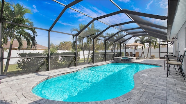 view of pool with glass enclosure, an in ground hot tub, and a patio area