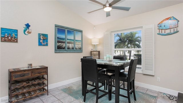 tiled dining room with ceiling fan and vaulted ceiling