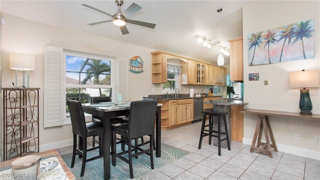 dining space with ceiling fan and light tile patterned floors