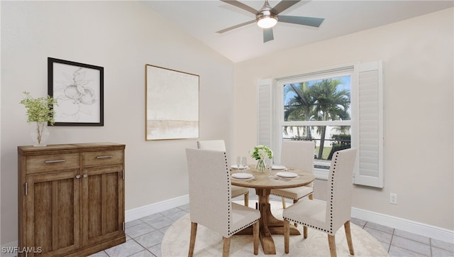 dining area with ceiling fan, vaulted ceiling, and light tile patterned flooring