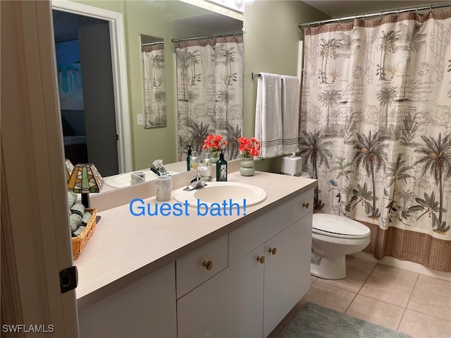 bathroom featuring vanity, toilet, and tile patterned flooring