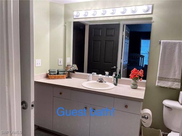 bathroom featuring vanity and toilet
