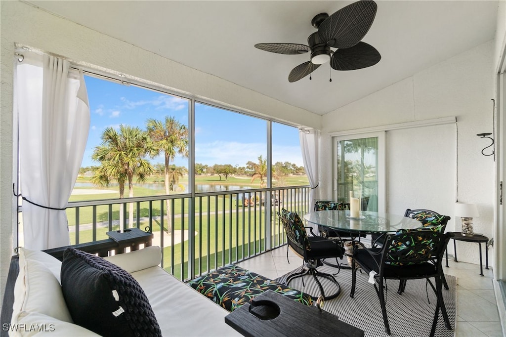 sunroom with ceiling fan and vaulted ceiling