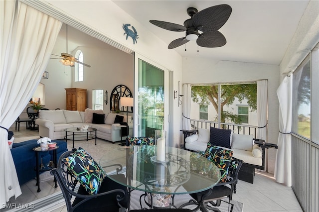 sunroom with ceiling fan and lofted ceiling