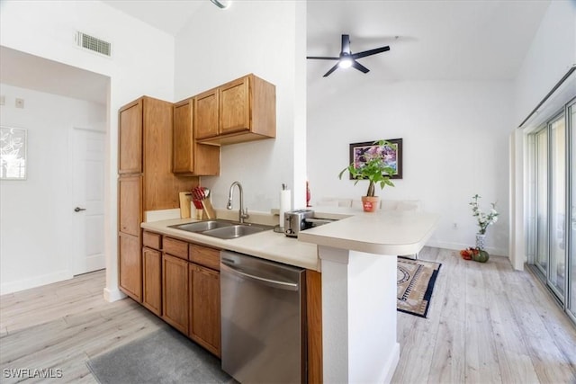 7925 Preserve Cir Unit 333, Naples, FL 34119 - kitchen featuring stainless steel dishwasher, a sink, light countertops, light wood-style flooring, and vaulted ceiling