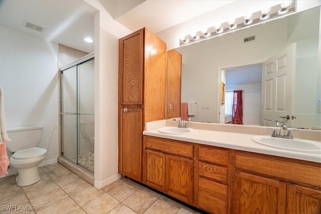 bathroom featuring vanity, a shower with shower door, toilet, and tile patterned flooring