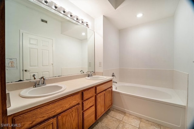 bathroom featuring vanity, a bathtub, and tile patterned flooring