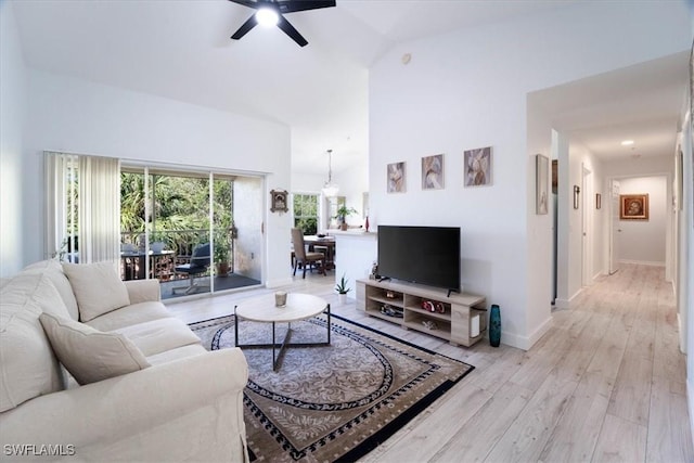 7925 Preserve Cir Unit 333, Naples, FL 34119 - living area featuring ceiling fan, light wood-style floors, baseboards, and high vaulted ceiling