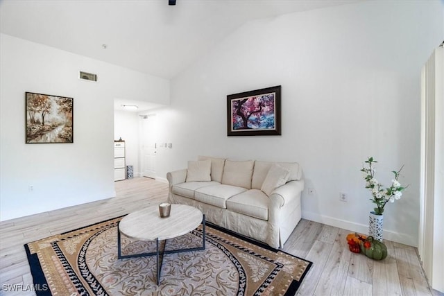 7925 Preserve Cir Unit 333, Naples, FL 34119 - living room featuring wood finished floors, lofted ceiling, and baseboards