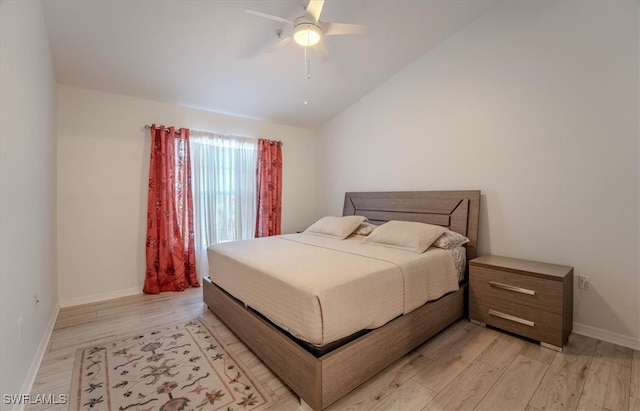 bedroom with light hardwood / wood-style floors, vaulted ceiling, and ceiling fan