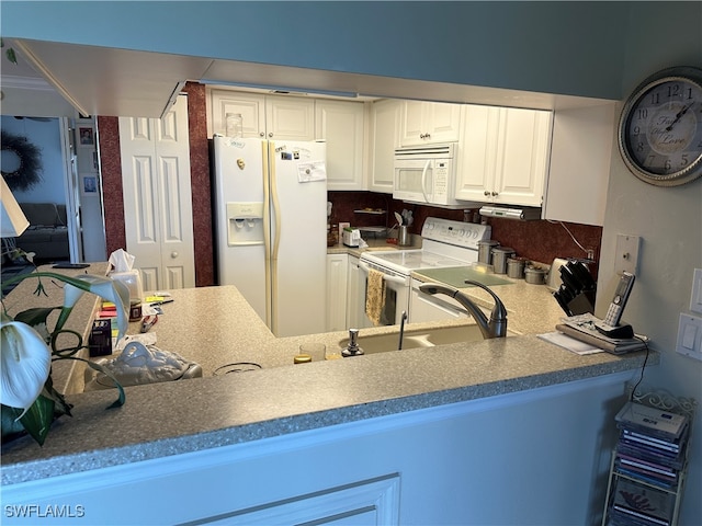 kitchen featuring white cabinets, tasteful backsplash, white appliances, and sink