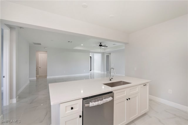 kitchen with a kitchen island with sink, ceiling fan, sink, white cabinetry, and stainless steel dishwasher