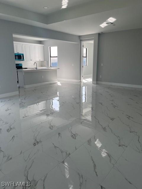 unfurnished living room with sink