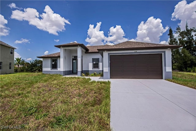 view of front of property with a garage and a front lawn