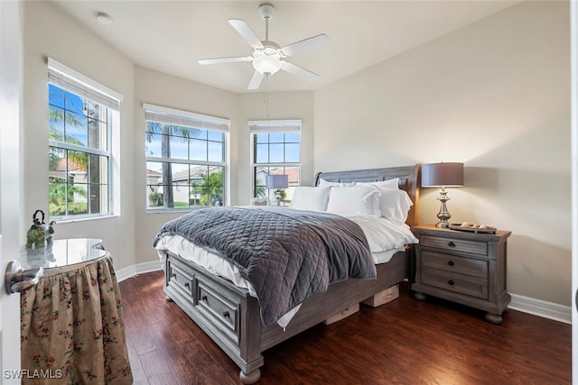 bedroom with dark hardwood / wood-style floors and ceiling fan