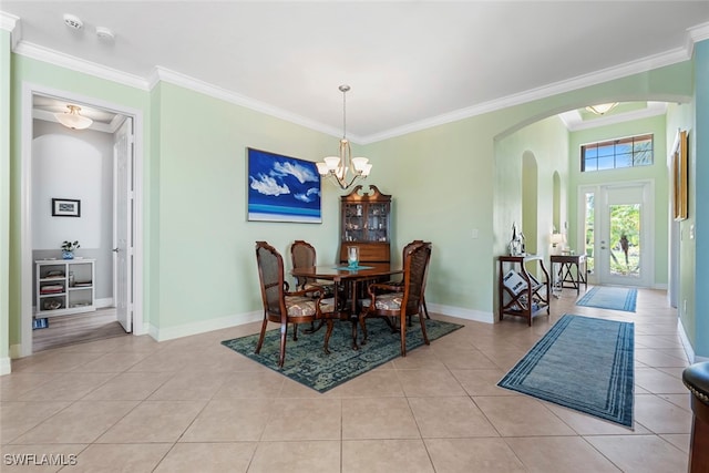 tiled dining space with a notable chandelier and ornamental molding