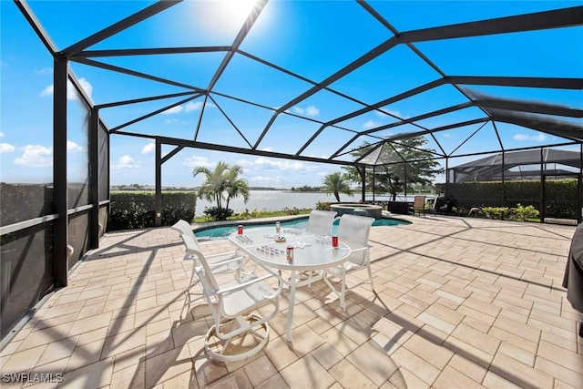 view of swimming pool with glass enclosure, a pool with connected hot tub, and a patio area