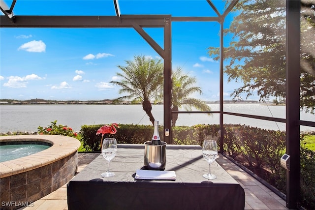 view of patio / terrace featuring an in ground hot tub and a water view