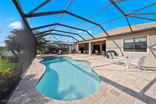 view of swimming pool featuring a patio, a lanai, and a pool with connected hot tub