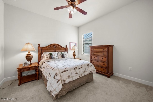 bedroom with light carpet, ceiling fan, and baseboards