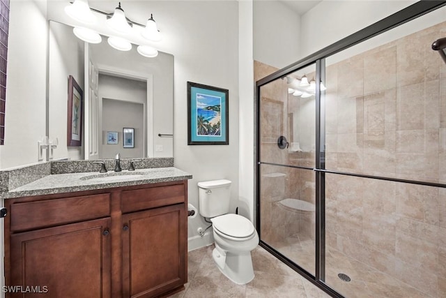 full bathroom featuring toilet, a shower stall, tile patterned flooring, and vanity