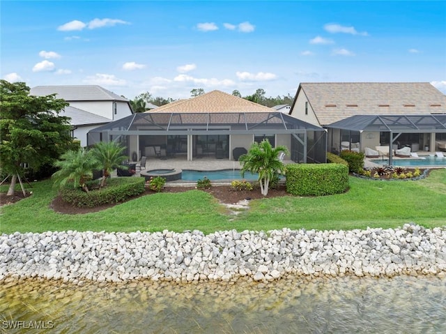 back of property with an in ground hot tub, a water view, glass enclosure, and an outdoor pool