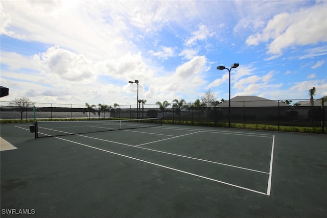 view of tennis court with fence