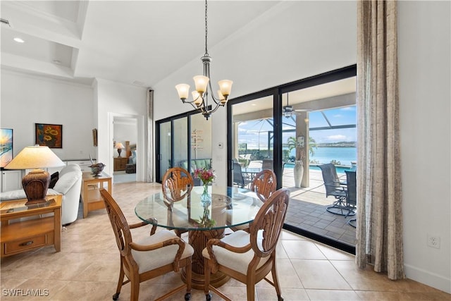 dining space with light tile patterned flooring, a high ceiling, a water view, visible vents, and a sunroom