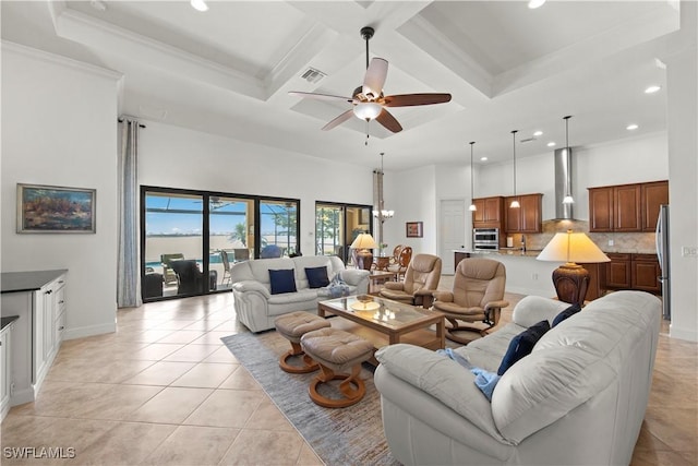 living room with crown molding, light tile patterned floors, a high ceiling, coffered ceiling, and ceiling fan with notable chandelier