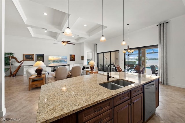 kitchen featuring hanging light fixtures, stainless steel dishwasher, a sink, light stone countertops, and ceiling fan with notable chandelier